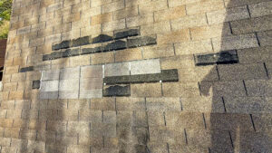 Roof leaks during heavy rain causing visible water damage on residential roof in storm conditions