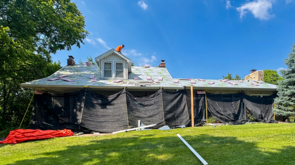 Contractor installing sustainable roof materials on a Missouri home during an eco-friendly roof replacement project.