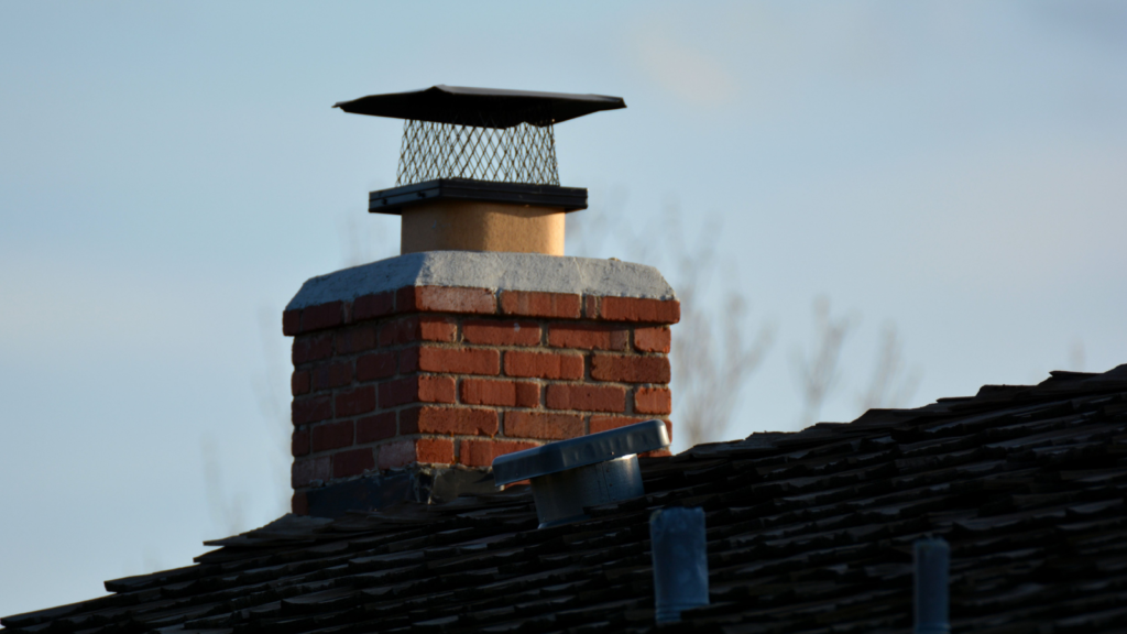 Chimney cap roof leak showing signs of water intrusion around a chimney